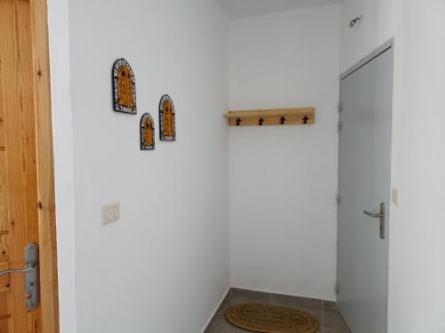 a white bathroom with a shower and a toilet at Le nid cosy in Tabarka