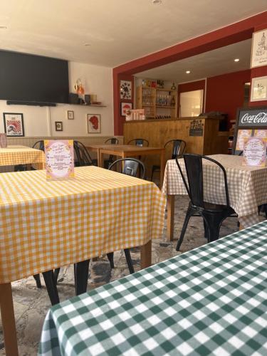un restaurant avec deux tables à carreaux jaunes et blancs dans l'établissement Auberge U Pampasgiolu, à Galéria
