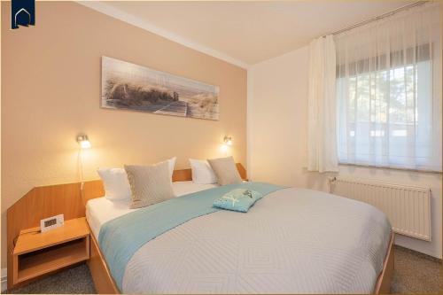 Postel nebo postele na pokoji v ubytování Nur 100 m zum Strand FeWo Meerweh