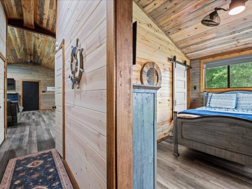 a bedroom with a bed in a wooden cabin at Floatin Daze in Wright City