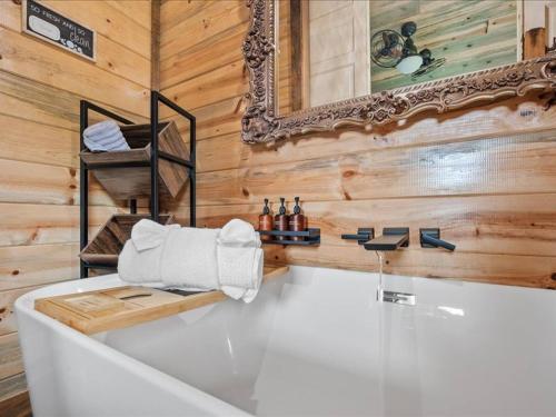 a bath tub in a bathroom with wooden walls at Floatin Daze in Wright City