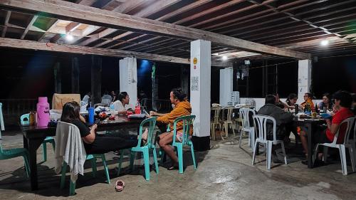 a group of people sitting at tables in a restaurant at BATAD Simons Viewpoint Inn and Pizza Restaurant in Banaue