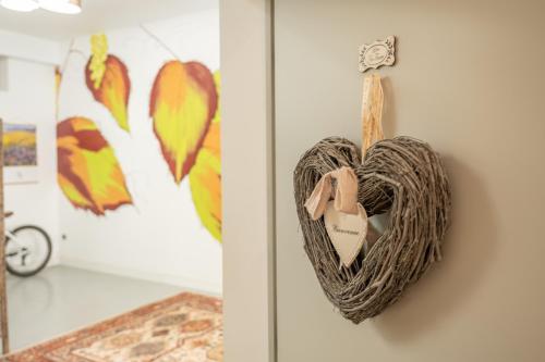 a heart shaped wreath is hanging on a wall at Loft de charme 4 étoiles confort haut de gamme garage privatif in Barr