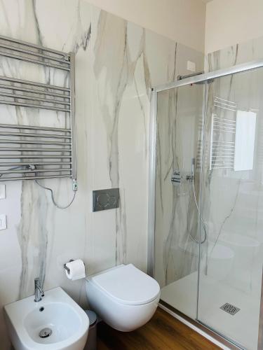 a bathroom with a shower and a toilet and a sink at Il Giardinetto - Guest Room Policlinico in Messina