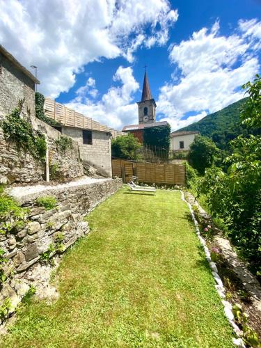 a stone building with a church in the background at Casa Salino in Salino