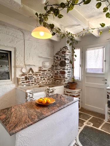 a kitchen with a bowl of oranges on a counter at Jasmine of Cyclades in Kinion