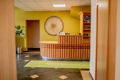 a lobby with a waiting room with yellow walls at Hotel Donau-Ries in Mertingen