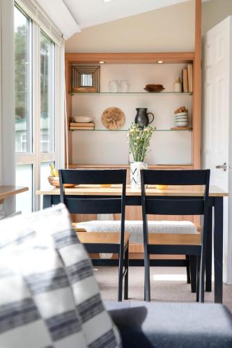 a dining room with a table and two chairs at The Chester-2 bed Static Caravan in Oxnam