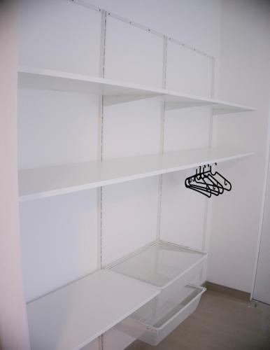 a white closet with white shelves in a room at Ca' del Mar in Minturno