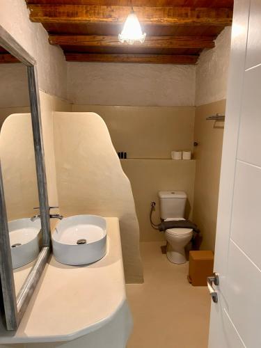a bathroom with a sink and a toilet at Jasmine of Cyclades in Kinion