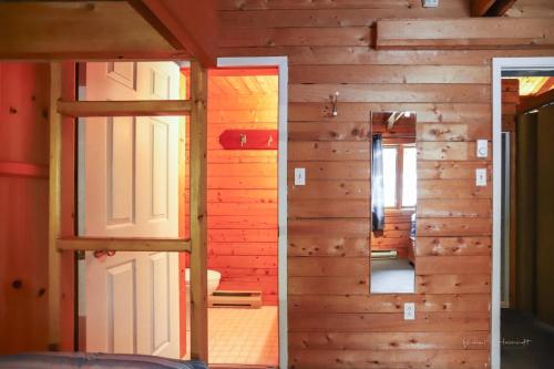 a room with a door and a mirror at Sherbrooke Lake Cottage with Private Beach in Mahone Bay