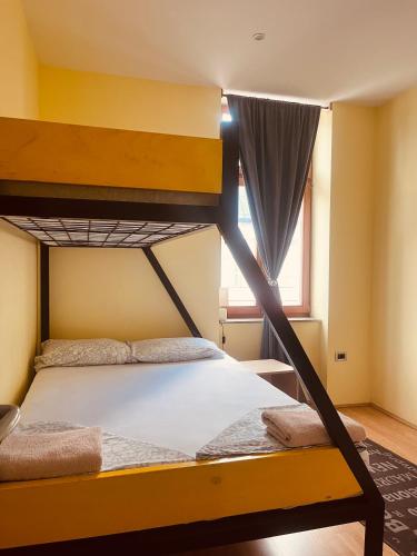 a bedroom with two bunk beds and a window at Apartman Vinkov's center in Jajce