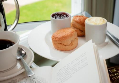 two plates of donuts and cups of coffee on a table at Lakeside Hotel and Spa in Newby Bridge