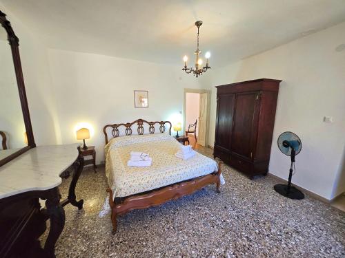 a bedroom with a bed and a dresser in it at Casa Clementina in Filetto