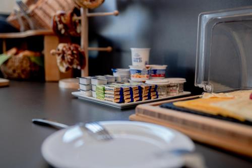 a counter with a plate of food on a table at Hotel Donau-Ries in Mertingen