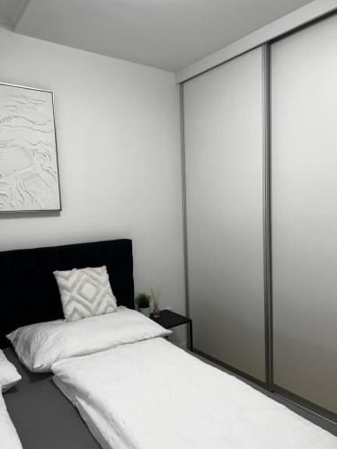 a bedroom with a bed with sliding glass doors at Apartment 98A7 in Povljana