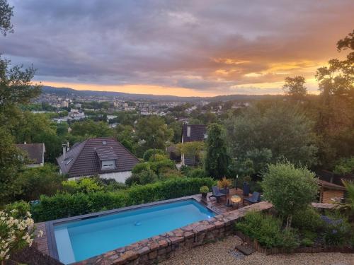 a swimming pool on top of a house at Brive, La Villa Bellevue in Buissou