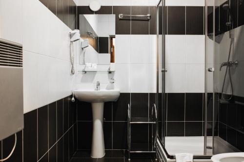 a bathroom with a sink and a shower at ZimaSnow Ski & Spa Club in Bukovel