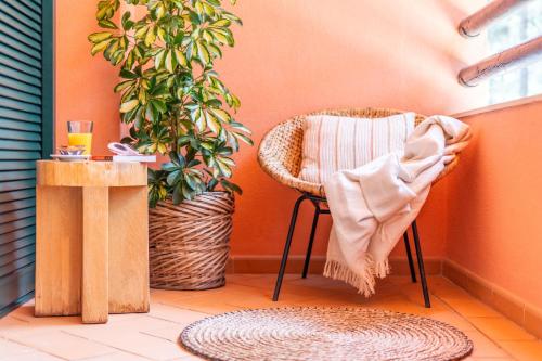 a room with a chair and a table and a plant at Apartment Aroeira Golf II in Carcereiro