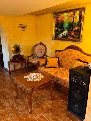 a living room with a couch and a table at Penzion Anička in Klokočov