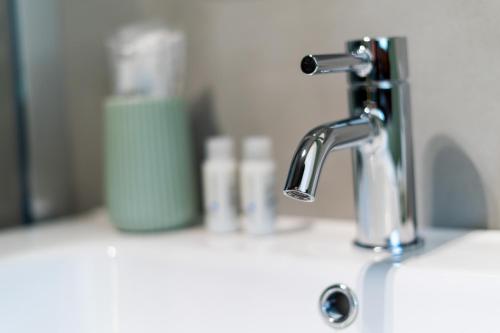 a bathroom sink with a faucet and a toothbrush at Tree Luxury in Baronissi