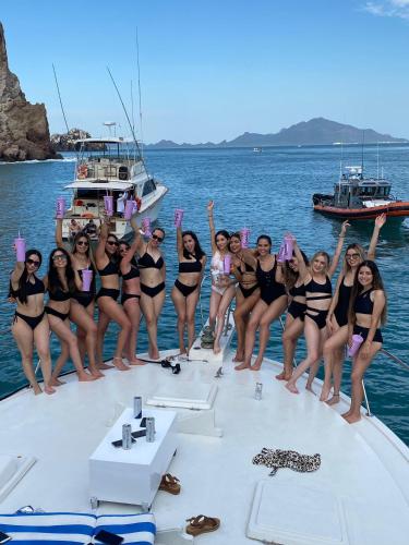 a group of women in bikinis posing on a boat at Yate Don Trini in San Carlos