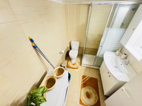 a bathroom with a toilet and a sink at Blue Pearl Chios apartment in Chios