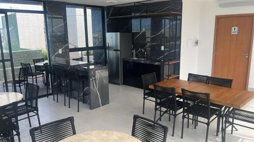 a kitchen and dining room with a wooden table and chairs at Apartment in Praia de Formosa in Cabedelo