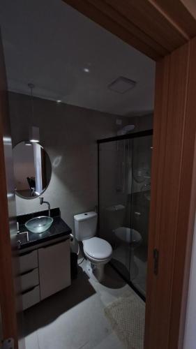 a bathroom with a toilet and a sink and a shower at Apartment in Praia de Formosa in Cabedelo
