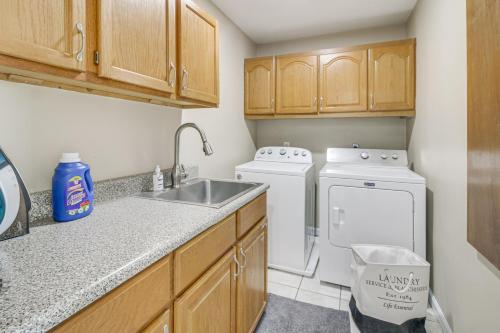 a kitchen with a sink and a washer and dryer at Spacious Home with Game Room, 2 Mi to Concord Mills! in Concord