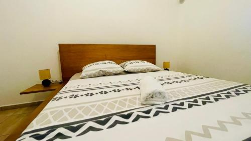 a bed with two pillows on top of it at Soleil Levant by Tropic Locations in Sainte-Rose
