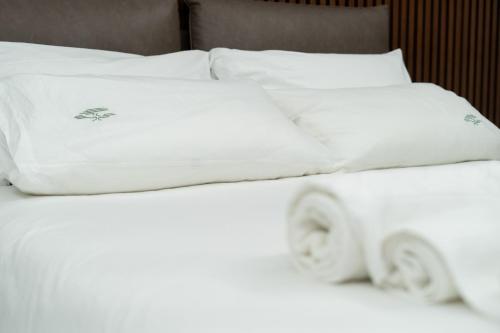 two white pillows sitting on top of a bed at Tree Luxury in Baronissi