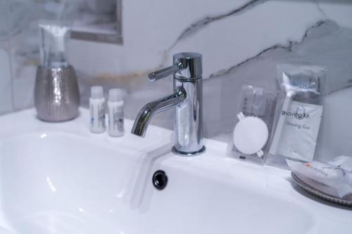 a bathroom sink with a faucet and other items on it at Tree Luxury in Baronissi
