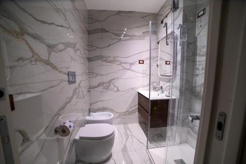 a bathroom with a shower and a toilet and a sink at Tree Luxury in Baronissi