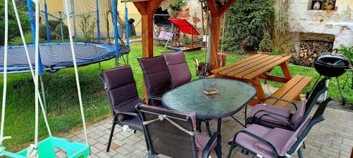 a patio with a table and chairs and a playground at Ubytování na Křížovce in Chlum u Třeboně