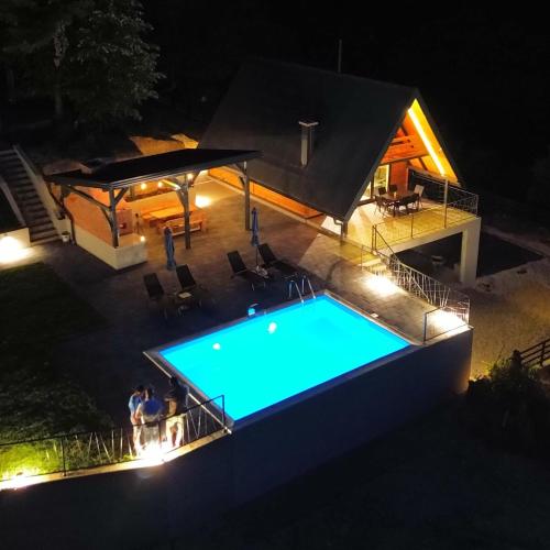 an overhead view of a swimming pool at night at Nale Luxury Chalet in Bratunac
