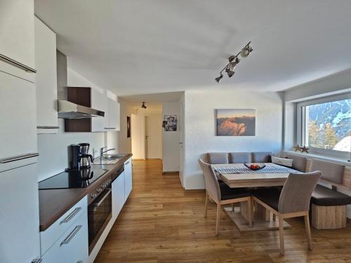 eine Küche und ein Esszimmer mit einem Tisch in der Küche in der Unterkunft Ferienwohnung Flir in Jerzens