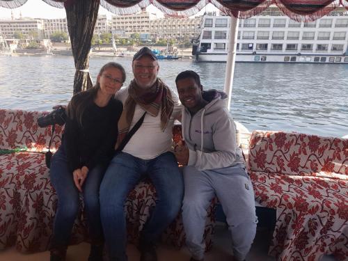 a group of three people sitting on a couch at Habob Nubian Guest House in Aswan