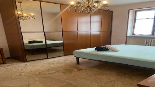 a bedroom with a large mirror and a bed at La Tua Pausa Torinese in Turin