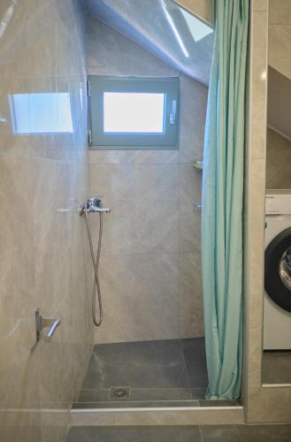 a bathroom with a shower with a shower curtain at Kythira echoes stay - Lithari in Kythira