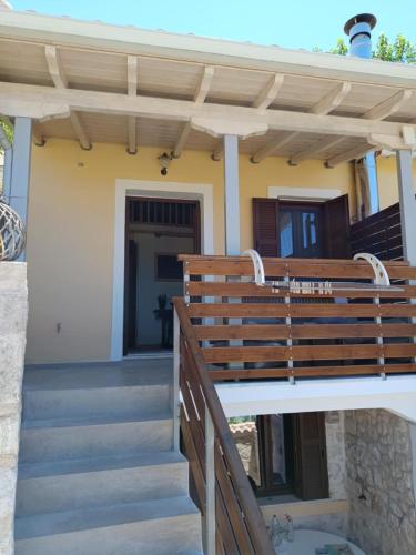 a staircase leading to a house with a wooden roof at Maniaveta's House in Exanthia