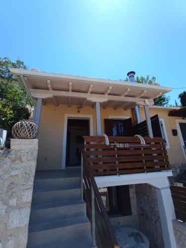 a wooden pergola on a house with stairs at Maniaveta's House in Exanthia