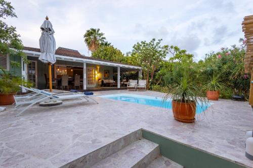 an image of a backyard with a swimming pool and a house at Piscadera Bay Resort 79 in Willemstad