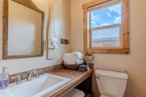 a bathroom with a sink and a mirror and a toilet at Rangers Retreat in West Yellowstone