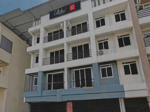 a building with a sign on the side of it at Hotel O Bhumi World in Bhiwandi