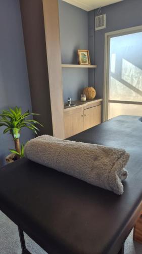 a bedroom with a bench with a book shelf at DAKAR HOTEL in Mendoza