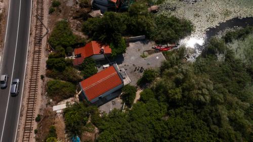 an overhead view of a house with trees and a road at Lake House Buric in Vranjina