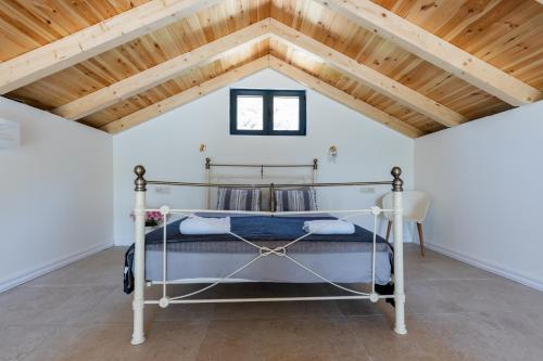 a bedroom with a bed and a wooden ceiling at Lake House Buric in Vranjina