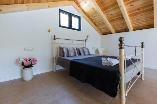 a bedroom with a bed and a wooden ceiling at Lake House Buric in Vranjina