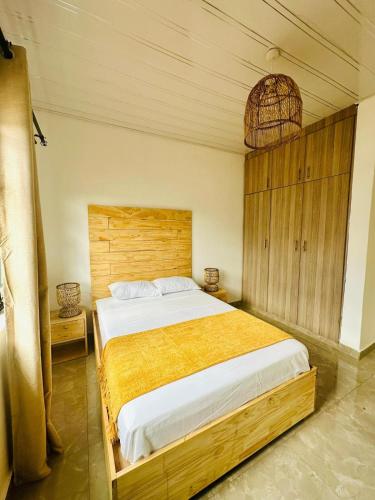 a bedroom with a large bed with a wooden headboard at Mulanje Vista House in Mulanje